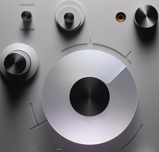 Close-up of various metallic control knobs and dials on a sleek gray surface, including a large central dial with a black center.